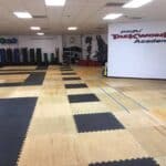Emmons Taekwondo - A TaeKwonDo studio with a gym floor and mats.